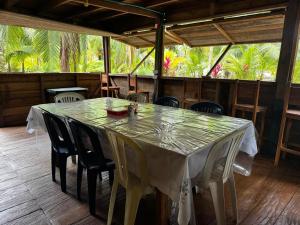 a dining room with a table and chairs and trees at HOSPEDAJE DOÑA NEL in El Valle