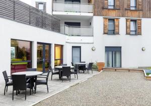 a patio with tables and chairs in front of a building at Zenao Appart'hôtels Strasbourg in Strasbourg
