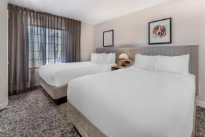 a hotel room with two beds and a window at Sonesta ES Suites Anaheim Resort Area in Anaheim