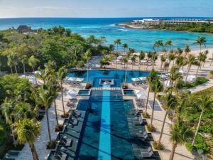 an aerial view of a resort with a pool and the beach at Conrad Tulum Riviera Maya in Tulum