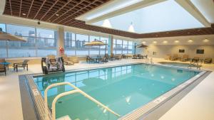 a large swimming pool with chairs and tables in a building at Caesars Windsor Hotel & Casino - A Caesars Rewards Destination in Windsor