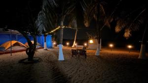 a tent and chairs on a beach at night at Beach vibe in Udupi