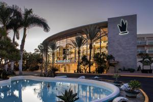 a hotel with a swimming pool in front of a building at Tabaiba Princess in Maspalomas