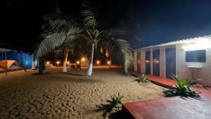 a resort with palm trees on the beach at night at Beach vibe in Udupi