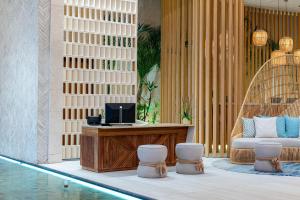 a hotel lobby with a desk with a computer on it at Hilton Tulum Riviera Maya All-Inclusive Resort in Tulum