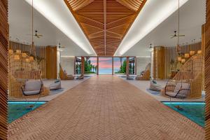 a hotel lobby with a pool and a view of the ocean at Hilton Tulum Riviera Maya All-Inclusive Resort in Tulum