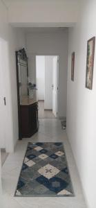 a hallway with a mirror and a rug on the floor at Casa da Gena in Nazaré