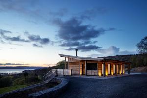a house on a hill with a view of the water at Kelburn Yurts - Cockle in Fairlie