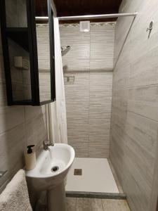 a small bathroom with a sink and a shower at La Caserma -The Barracks in Bobbio Pellice +47 photos