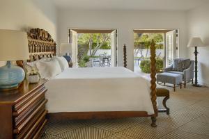 a bedroom with a large bed and a chair at La Quinta Resort & Club in La Quinta +136 photos