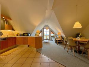 a kitchen and dining room with an attic at Oewern Diek App 09 in Wustrow