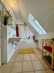 a bathroom with a sink and a bath tub at Oewern Diek App 09 in Wustrow +15 photos