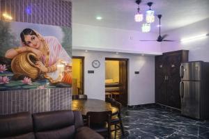 a room with a painting of a woman playing a instrument at Elite Castle Stay in Kottakupam