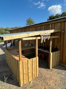 a wooden shed with a sign on it at Luxury Glamping - Heydaze in Lostwithiel