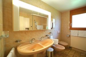 a bathroom with a sink and a toilet at Chalet Miravalle 3 in Wengen +30 photos