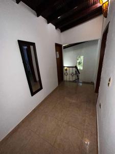 an empty room with white walls and a table at Hostal White beach in Paraguchi