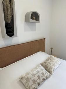 a white bed with a pillow on top of it at Savane 2 bedrooms and private parking in Vesoul
