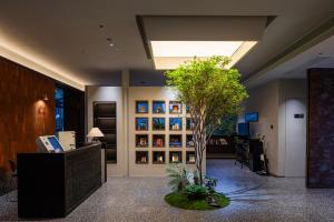 an office with a tree in the middle of a lobby at Hidden Valley Hotel-- New Hotel,A Hidden Gem,Serene Sanctuary,Exclusive Location,Swimming Pool & Cycling Route,Attraction Tickets Serivce in advance,Affordable Luxury,Best Karst Mount View in Yangshuo in Yangshuo +249 photos