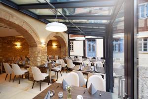 a restaurant with tables and chairs in a building at GUT LEBEN am Morstein in Westhofen