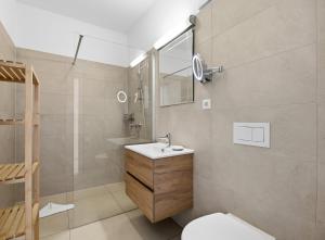 a bathroom with a sink and a toilet and a shower at Residenz Waldhaus_05 in Zempin