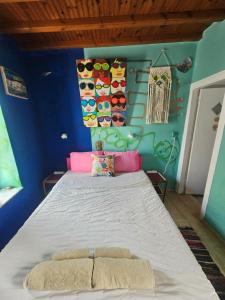 a bedroom with a bed with a blue wall at LaLaLand in Mikonos