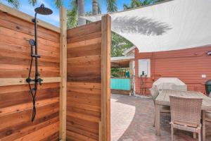 a wooden privacy fence with a table in a patio at 2 Cottages Downtown Lake Worth - Private Pool in Lake Worth