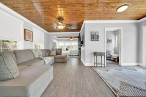 a living room with a couch and a wooden ceiling at 2 Cottages Downtown Lake Worth - Private Pool in Lake Worth +49 photos