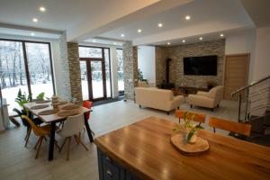 a living room with a dining table and a living room at La Stanca in Cheia
