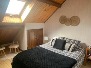 a bedroom with a bed with a black comforter at Chalet Masana in Murat-le-Quaire
