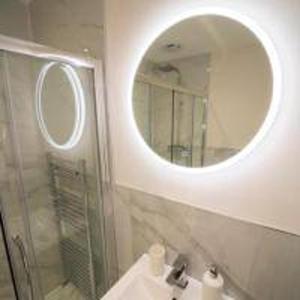 a bathroom with a mirror and a sink and a shower at Foundry Farm Cottage in Hexham +20 photos