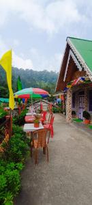 a group of tables and chairs with umbrellas at SOUPRIYA Impression Homestay in Pedong