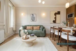 a living room with a green couch and a table at PoeticStay - Neuilly sur Seine - Dulud in Neuilly-sur-Seine
