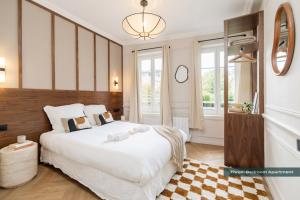 a bedroom with a large white bed and a mirror at PoeticStay - Neuilly sur Seine - Dulud in Neuilly-sur-Seine