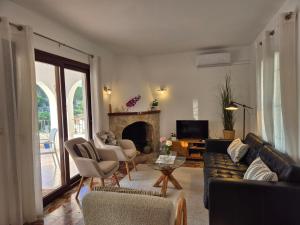a living room with a couch and chairs and a fireplace at Luciana in Moraira
