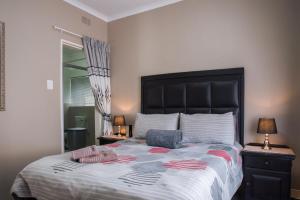 a bedroom with a large bed with two towels on it at Rusty Estate - Self Catering in eMalahleni