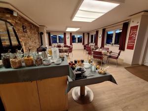 a kitchen with a table with food on it at Cafe und Pension Blohm in Greifswald