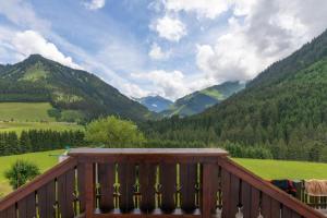 a wooden deck with a view of a mountain at Bergapartments Wötzinger in Berwang