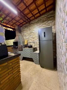 a kitchen with a stainless steel refrigerator and a stove at Chácara Betel in Marechal Deodoro