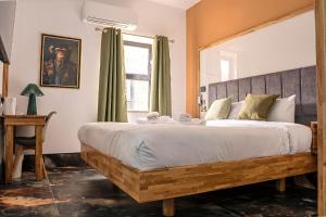 a bedroom with a large bed and a window at The Arundell Hotel in Boston