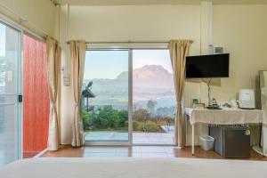 a bedroom with a view of a mountain at PATTA Hideaway Chiang Dao in Chiang Dao