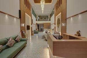 a hospital lobby with couches and a waiting room at Rajpath Beacon Hotel Belagavi in Belgaum