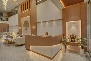 a lobby with a reception desk in a building at Rajpath Beacon Hotel Belagavi in Belgaum +15 photos