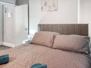 a bedroom with a large bed with a pink blanket at Rose - Uk49363 in Bridlington
