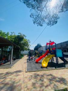 a playground with a slide in a park at Welcome2 in Kobuleti