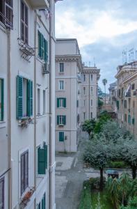 an alley between two buildings with green shutters at Long John Apartment in Rome