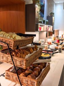 a bakery with baskets of bread and pastries on a counter at Hotel Le Saint Paul in Nice