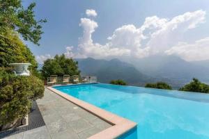a swimming pool with a view of the mountains at Villa Bellavista Lakeview Pool in Civenna