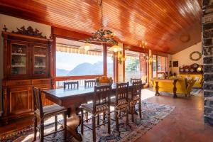 a dining room with a wooden table and chairs at Villa Bellavista Lakeview Pool in Civenna