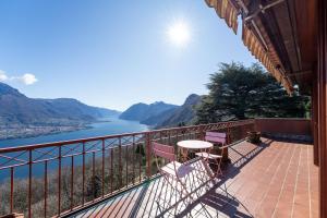 a balcony with a view of the water and mountains at Villa Bellavista Lakeview Pool in Civenna
