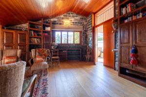 a living room with wooden floors and a room with bookshelves at Villa Bellavista Lakeview Pool in Civenna